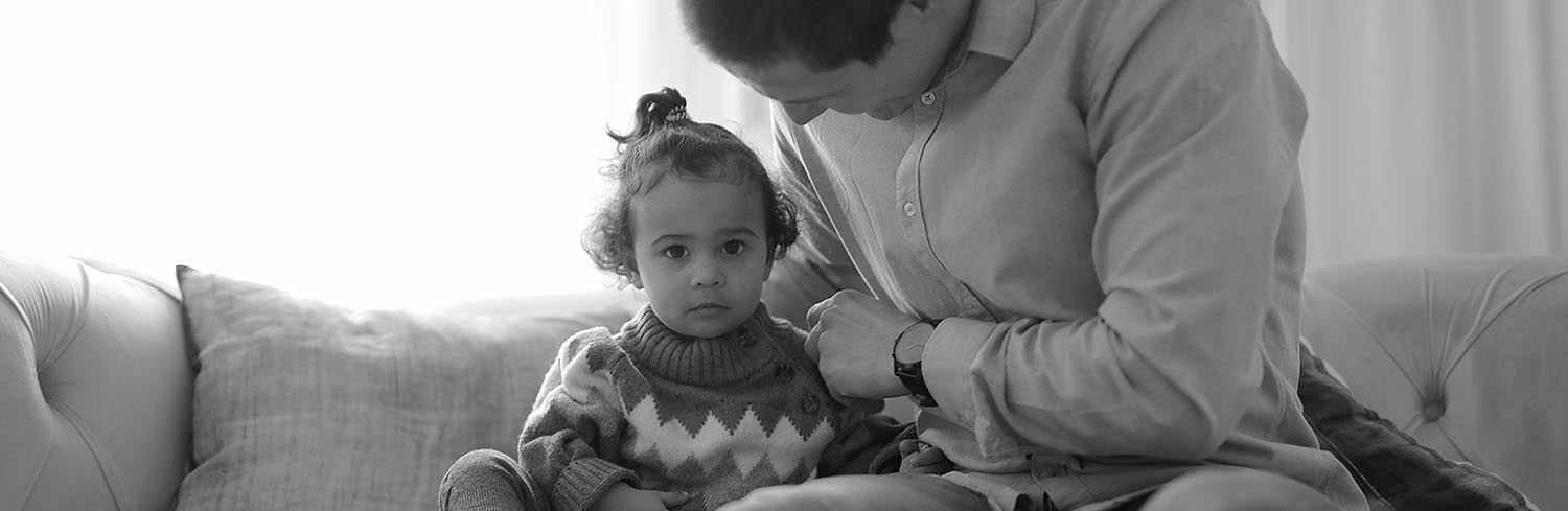 father and child sitting on couch